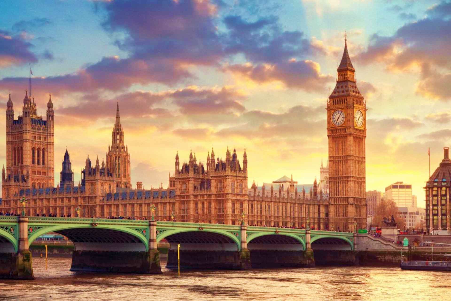 Big Ben and Houses of Parliament at sunset with Westminster Bridge over the River Thames in London